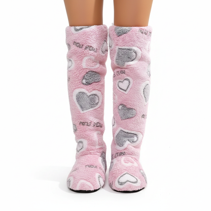 Pink fluffy knee-high slipper boots with grey and white heart pattern - back view